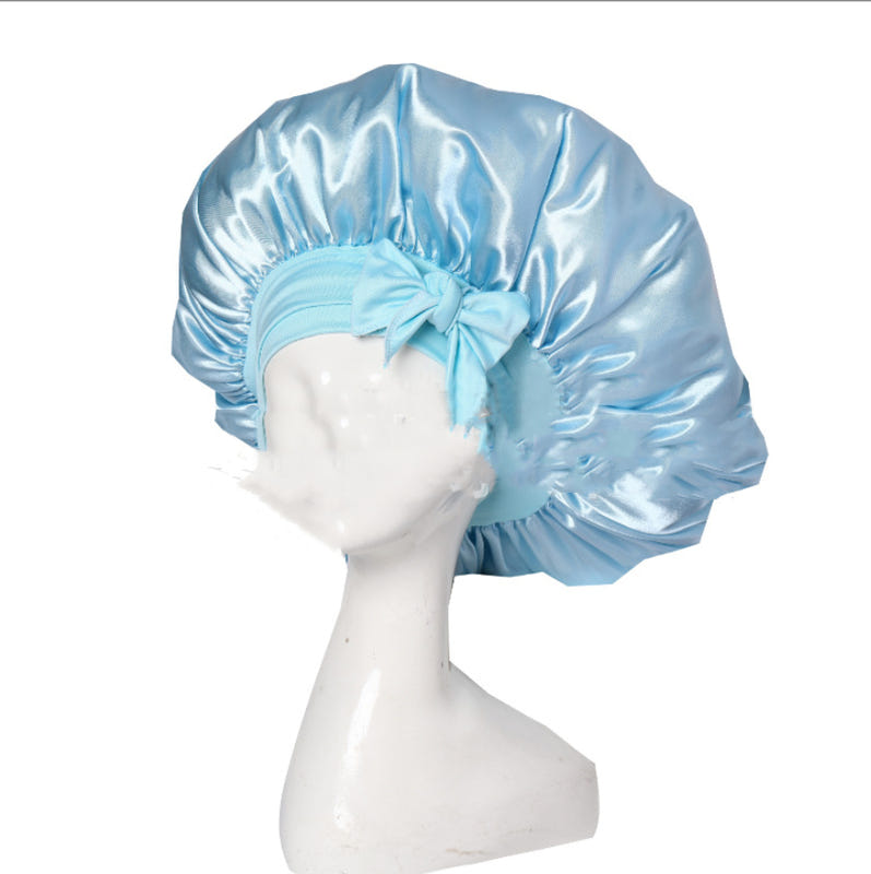 Light blue satin ribbon round cap with gathered double-layer ruffle and top tie bow.