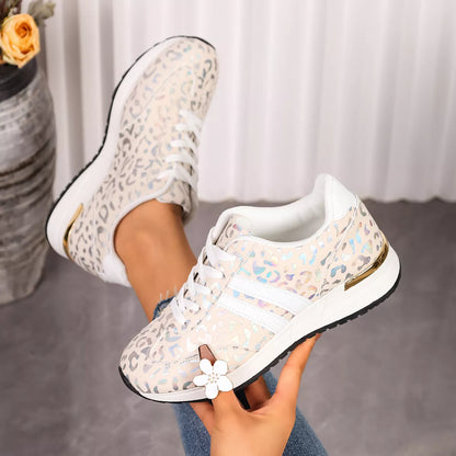 Leopard print lace-up sneakers with white laces and flower accent on side
