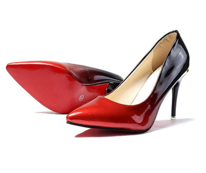 Red high-heeled shoes with a black heel on a white background