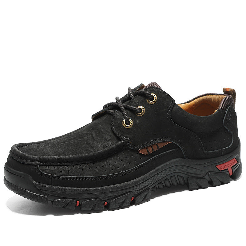 Black leather shoe with brown accents on a white background