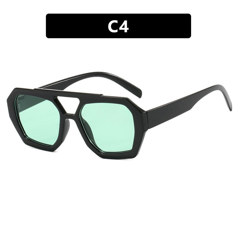 Sunglasses with black frame and green lenses on a white background