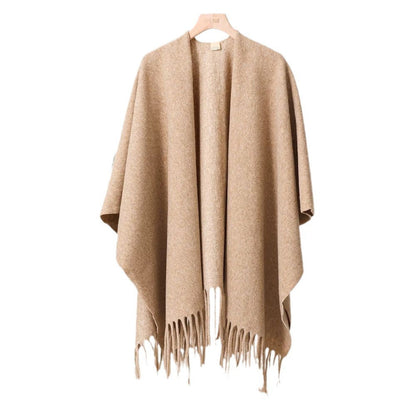 Beige poncho with fringe details on a white background