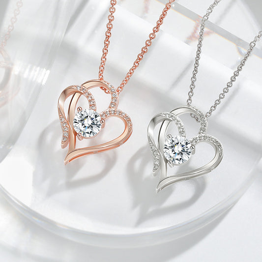 Two heart-shaped pendants on necklaces against a light background