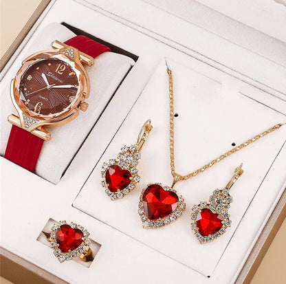 Jewelry set with red heart-shaped stones including a watch, necklace, and earrings on a white background.