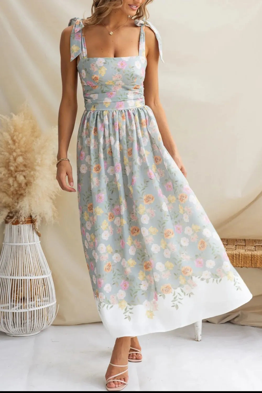 Woman wearing a floral dress with a neutral background