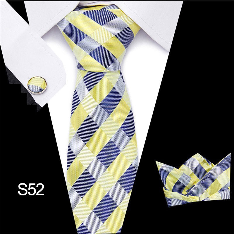 Plaid tie set with matching cufflinks and pocket square on a white shirt.