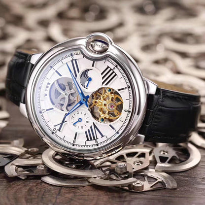 Mechanical multifunction watch with skeleton dial, blue accents, black leather strap, silver case