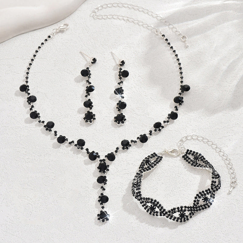Black crystal necklace, drop earrings, and matching bracelet set