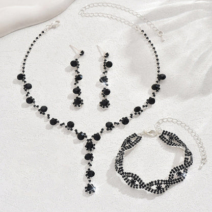 Black crystal necklace, drop earrings, and matching bracelet set