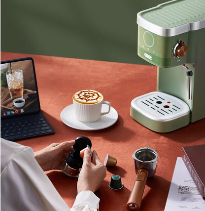 Green insulated home coffee maker on countertop with cup and hand