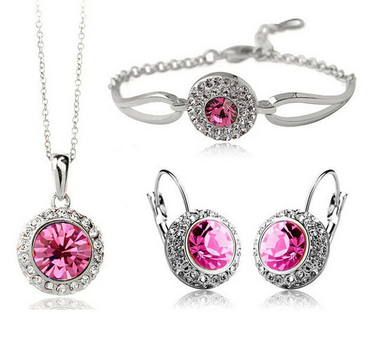 Jewelry set with pink gemstones including necklace, earrings, and bracelet on a white background
