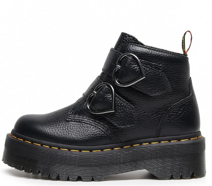 Black leather boot with heart-shaped buckles on a white background