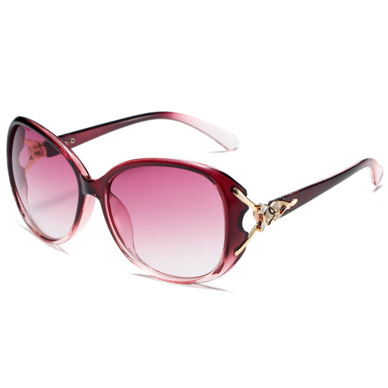 Oversized cat-eye sunglasses, red frame with pink gradient lenses and gold fox ornament