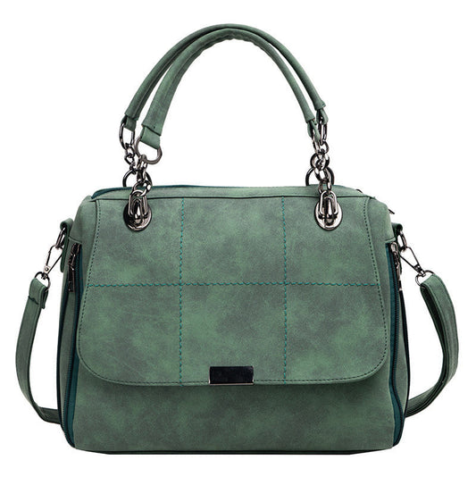 Large matte shoulder bag in green with front flap, metal ring handles, side zipper pockets