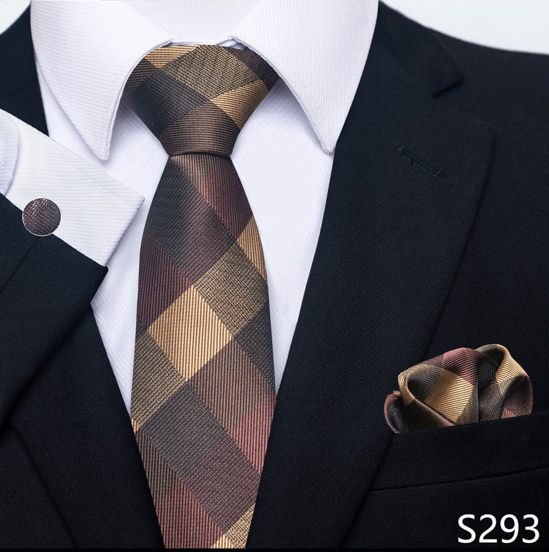 Man wearing a black suit with a plaid tie and matching pocket square.