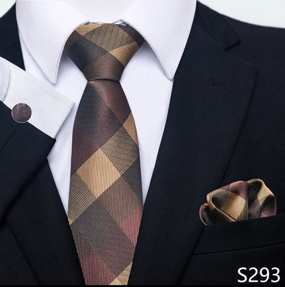 Man wearing a black suit with a plaid tie and matching pocket square.