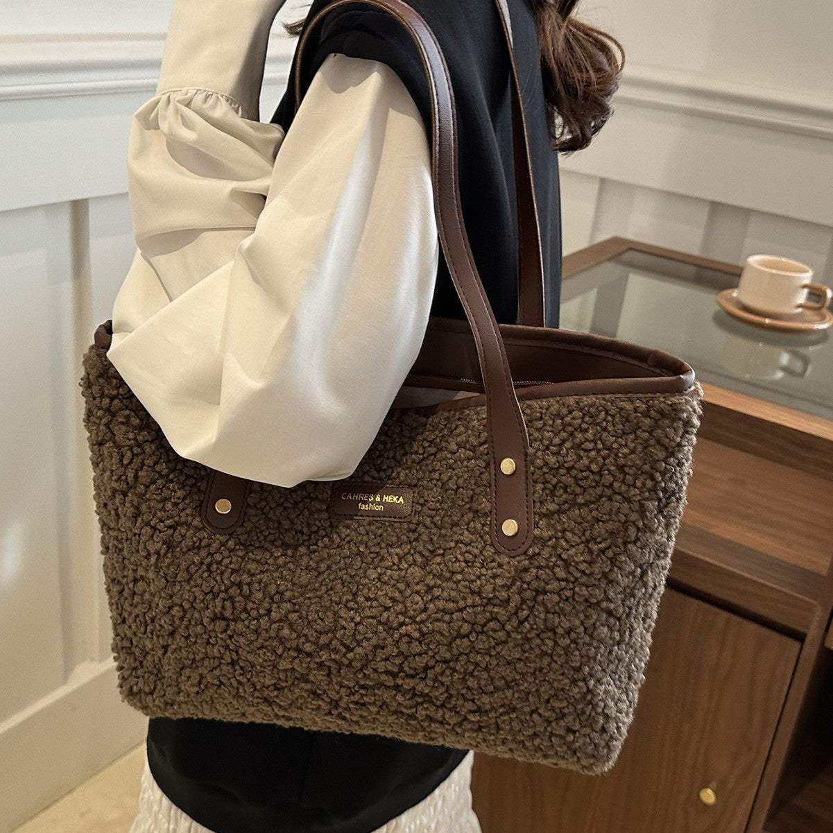 Dark brown fuzzy tote shoulder bag with top handles and snap button details