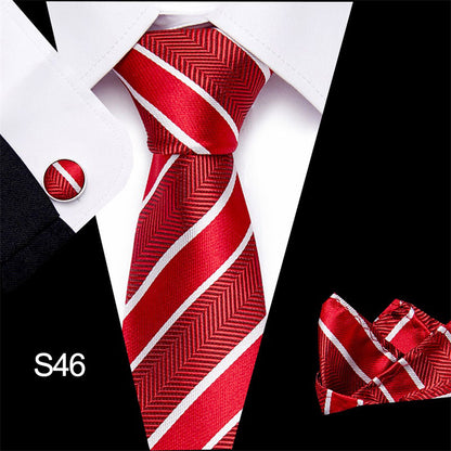 Red and white striped tie with matching pocket square and cufflinks on a black and white background.