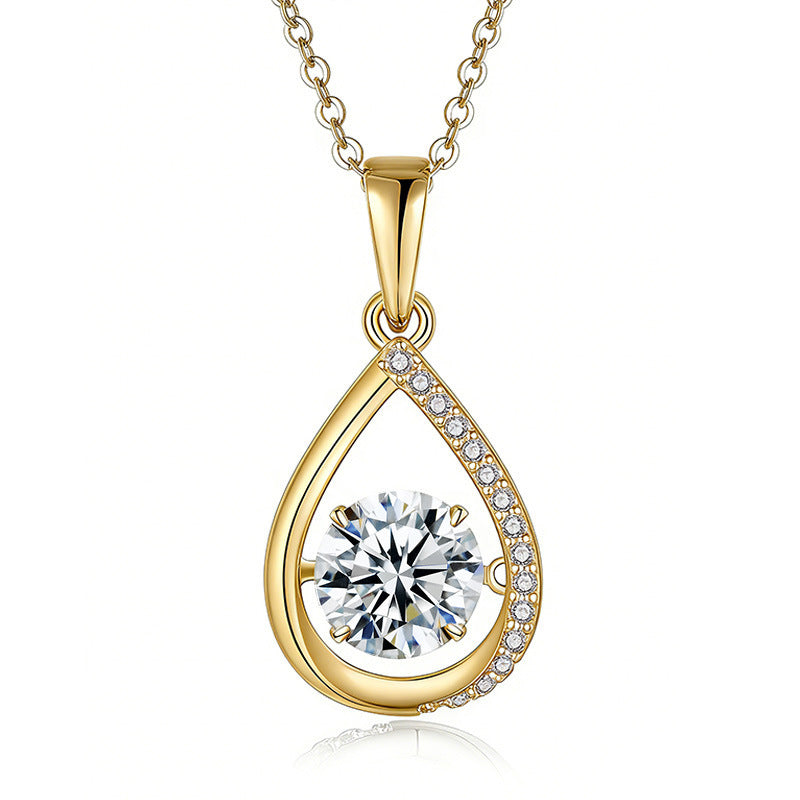 Gold teardrop-shaped pendant with a clear gemstone on a white background