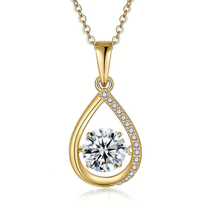 Gold teardrop-shaped pendant with a clear gemstone on a white background