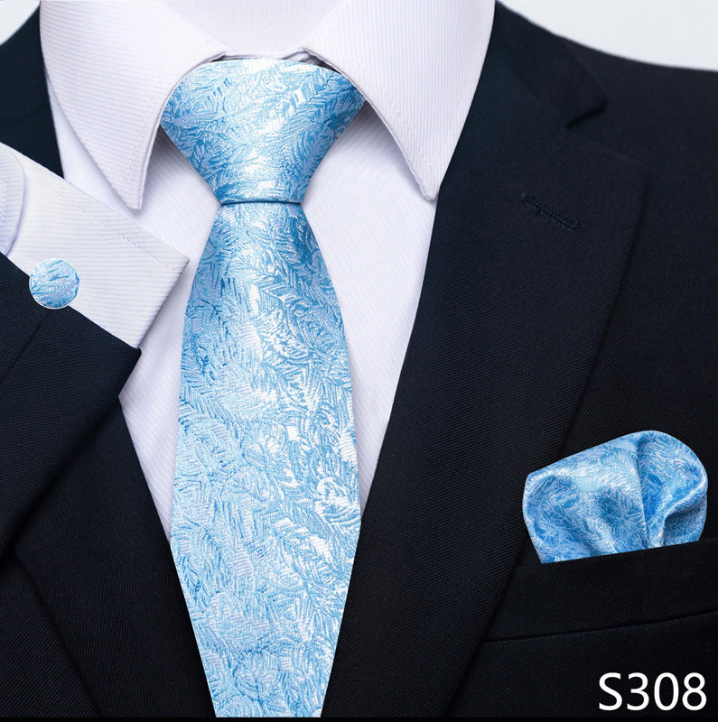 Blue patterned tie and pocket square set with a black suit and white shirt.