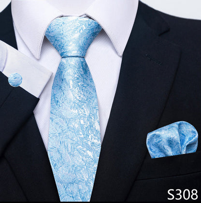 Blue patterned tie and pocket square set with a black suit and white shirt.