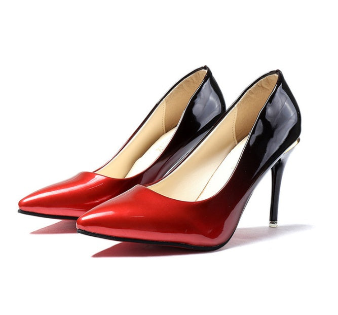 Pair of red and black high-heeled shoes on a white background