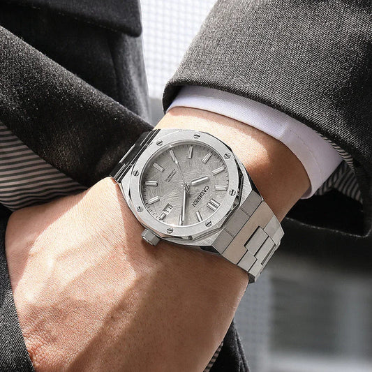 Stainless steel automatic mechanical watch with silver dial and metal bracelet.
