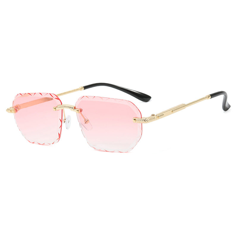 Sunglasses with pink lenses and gold frames on a white background