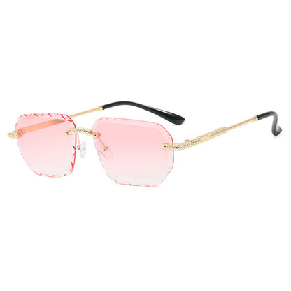Sunglasses with pink lenses and gold frames on a white background