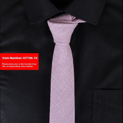 Black suit jacket with a pink tie and a red item number label.