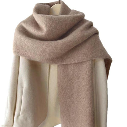 Beige scarf draped over a mannequin on a white background