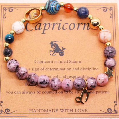 Zodiac bracelet with purple speckled and blue beads, gold-tone accents, and Capricorn charm