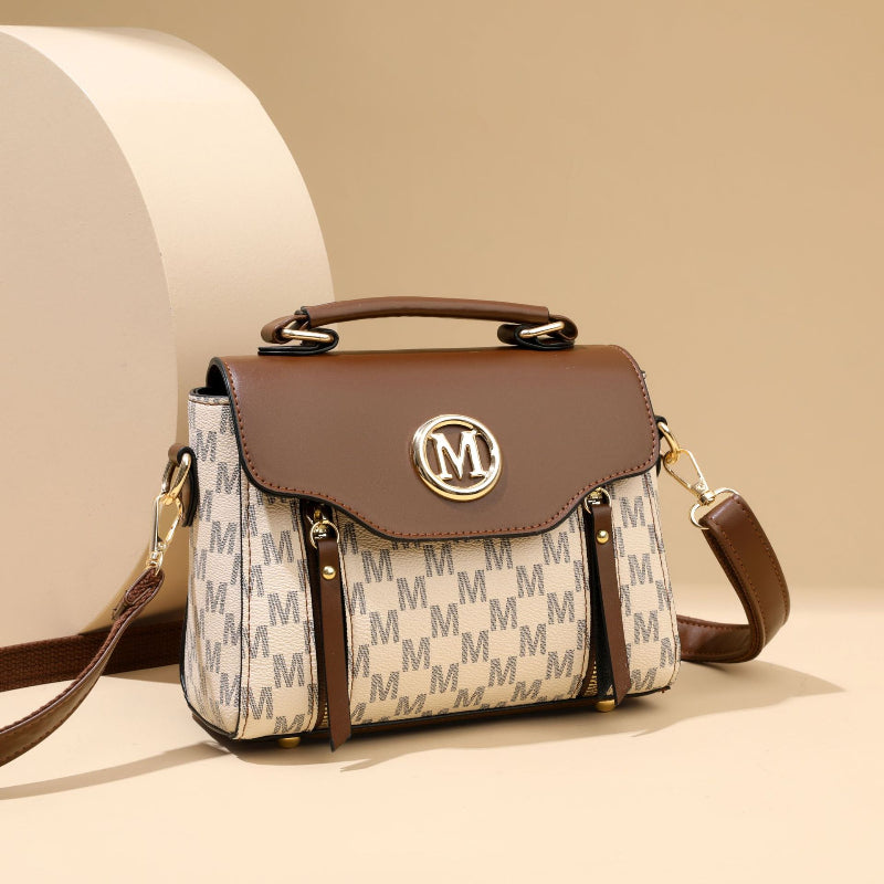 Designer handbag with brand logo on a beige background