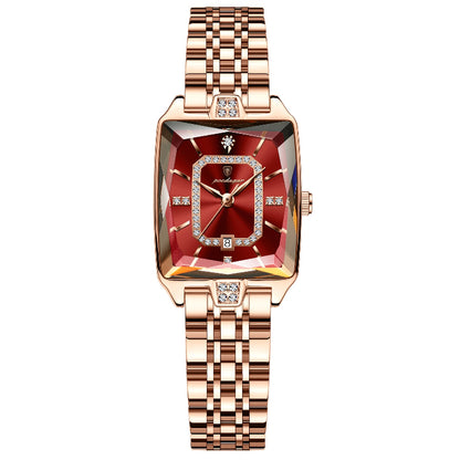 Luxury watch with rose gold strap and red face on a white background