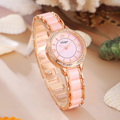 Rose gold round quartz wristwatch with pale pink dial and pink link bracelet