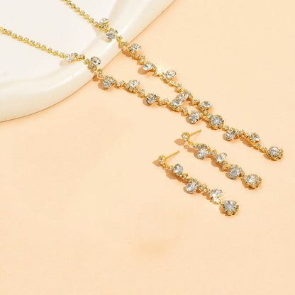 Gold crystal necklace, tennis bracelet, and dangling earrings set