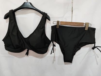 Black bikini set on hangers against a white background