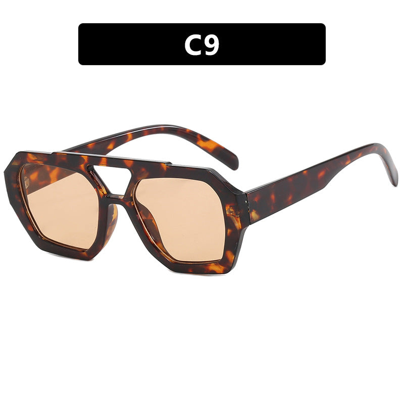 Sunglasses with tortoiseshell frame and beige lenses on a white background
