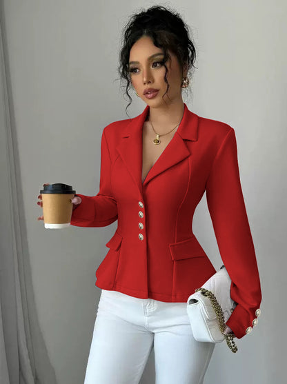 Woman in a red blazer holding a coffee cup against a plain background