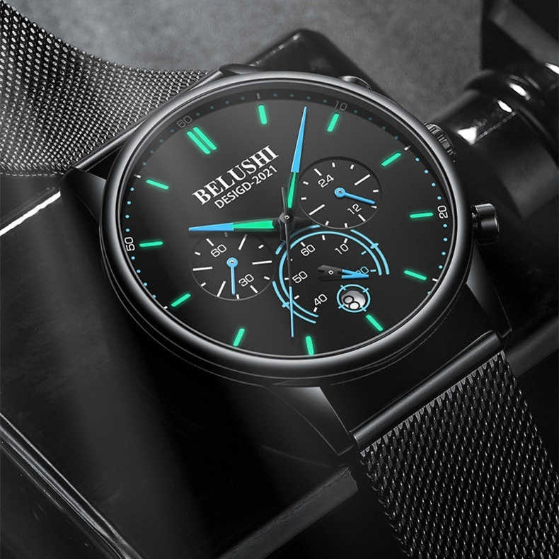 Black watch with green and blue accents on a dark background