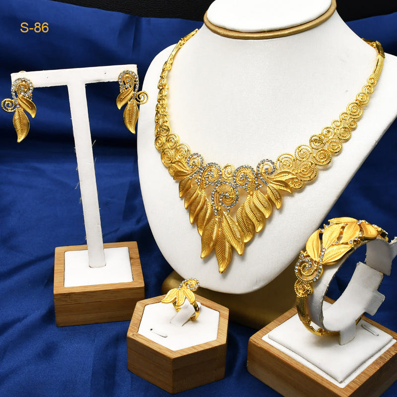 Gold-plated necklace with leaf drops plus matching earrings, ring, and bracelet on stands