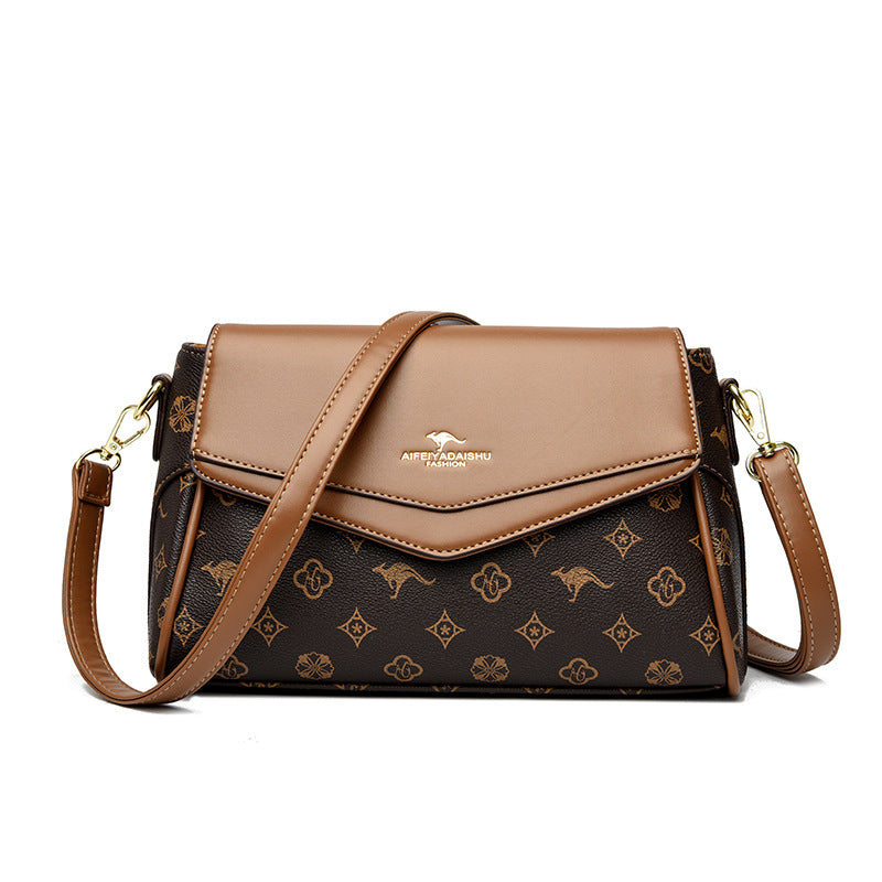 Brown and patterned handbag with a visible brand logo on a white background