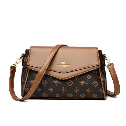 Brown and patterned handbag with a visible brand logo on a white background