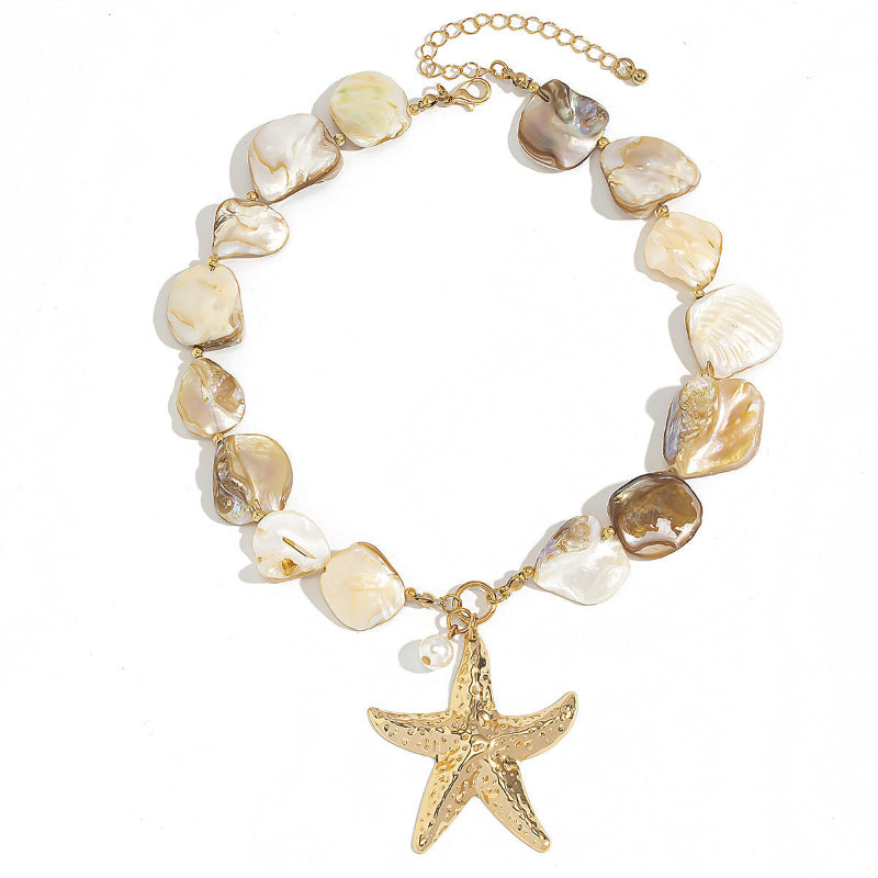 Women's Necklace with shell beads and a gold starfish charm on a white background