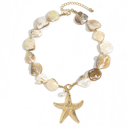 Women's Necklace with shell beads and a gold starfish charm on a white background