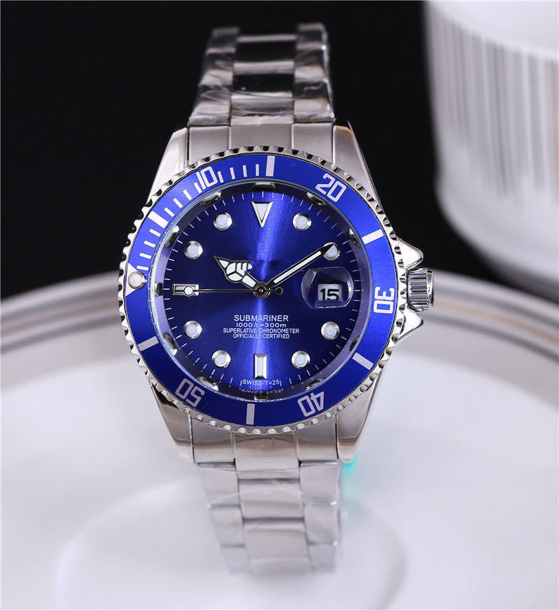 Steel wristwatch with blue dial, stainless bracelet, blue bezel with minute markers.