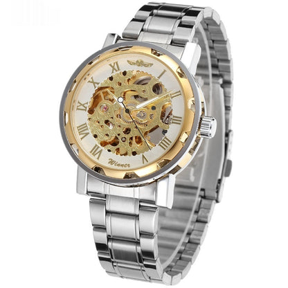 Silver and gold watch with transparent face on a white background