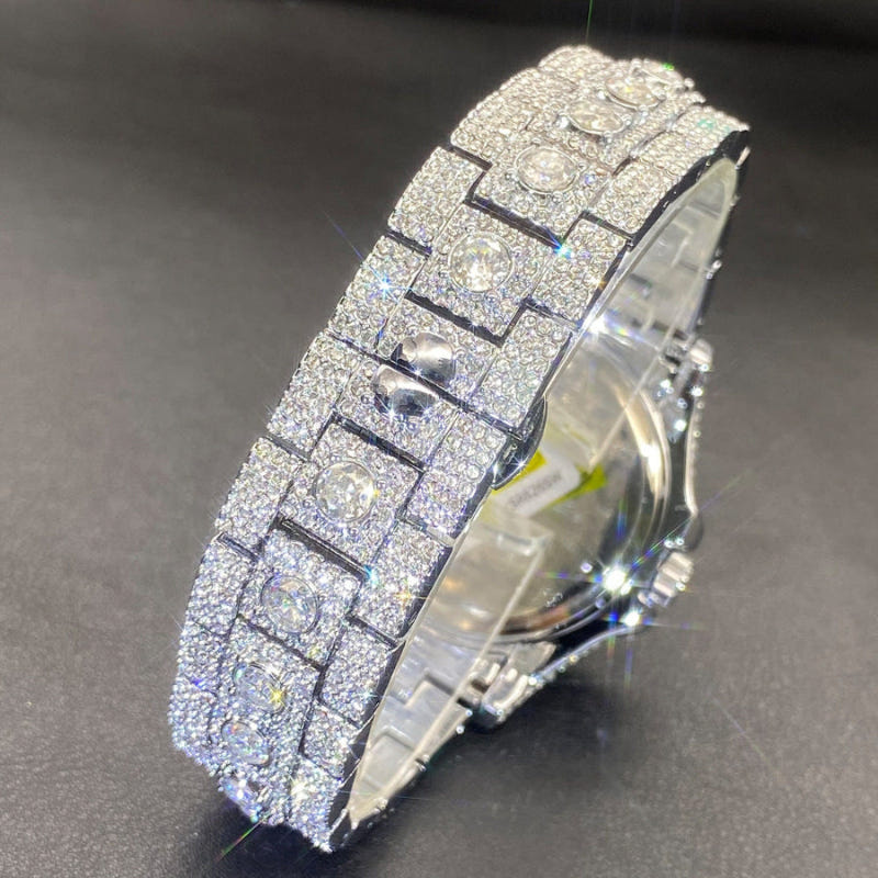 Diamond-encrusted watch, angled view showing glittering silver-toned strap links and crown.