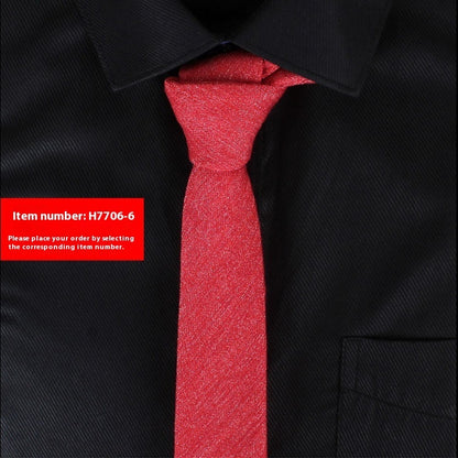 Red tie on a black shirt with a red label displaying an item number.